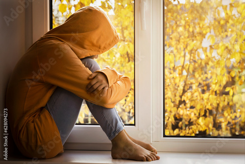 Stressed Unhappy Alone Sad Depressed Disappointed Teenager on Autumn Window Background. Autumn Depression Teen. Mental Health.  © Maryana