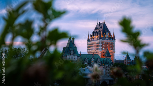 Nice view over the famous Chateau Frontenac hotel in the background, under the dusk light, blurred foreground. Old Quebec city, Canada photo