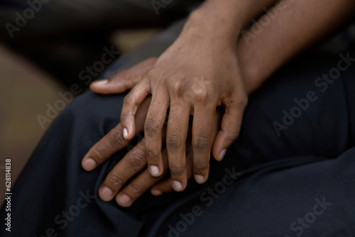 black couple in love hold each other hand, symbol of support trust and empathy © Mihail