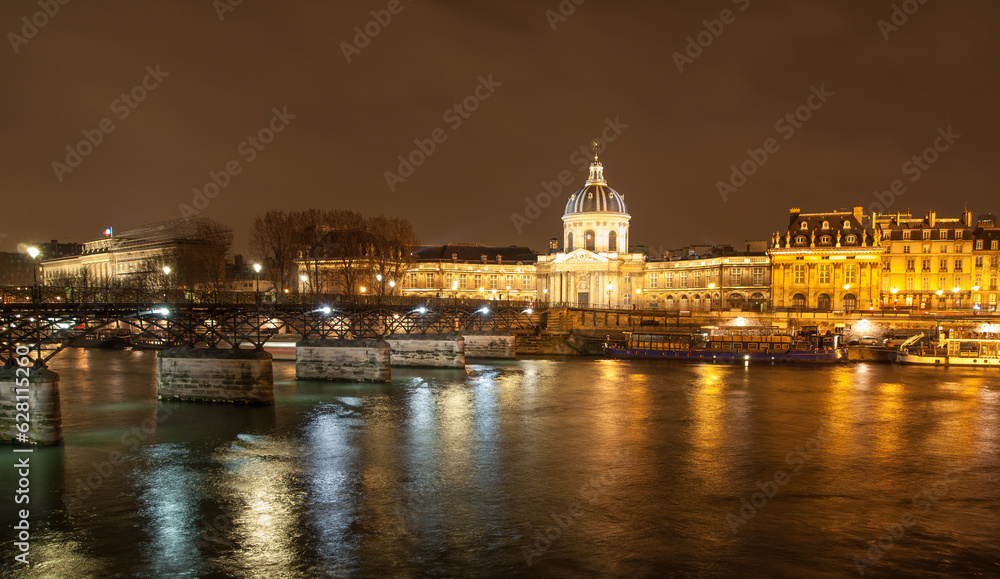 River Seine with Pont des Arts and Institut de France panorama at night in Paris, France. High quality photo