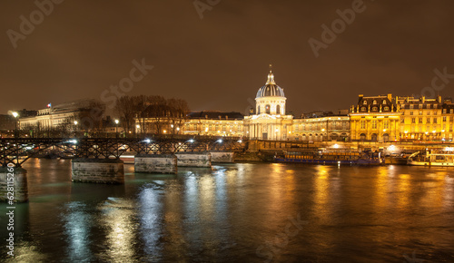 River Seine with Pont des Arts and Institut de France panorama at night in Paris, France. High quality photo