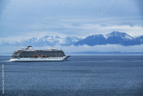 Breathtaking mountain glacier range view with luxury cruiseship cruise ship liner Orion sailing in front of Alaska mountains departure from Hoonah, Icy Strait Point with spectacular landscape scenery photo