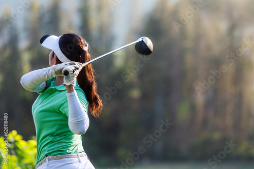 Golfer sport course golf ball fairway. People lifestyle woman playing game golf tee off on the green grass. Asia female player game shot in summer. Healthy and Sport outdoor