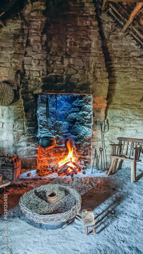 Cast iron cauldron over an open turf fire in a traditional Irish cottage.