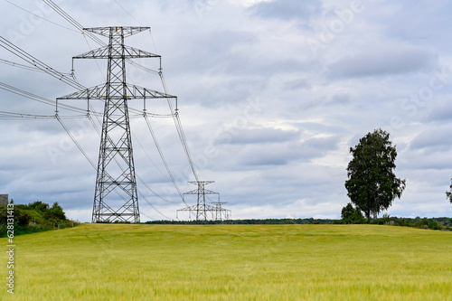 Power lines over fields a cloudy summers day