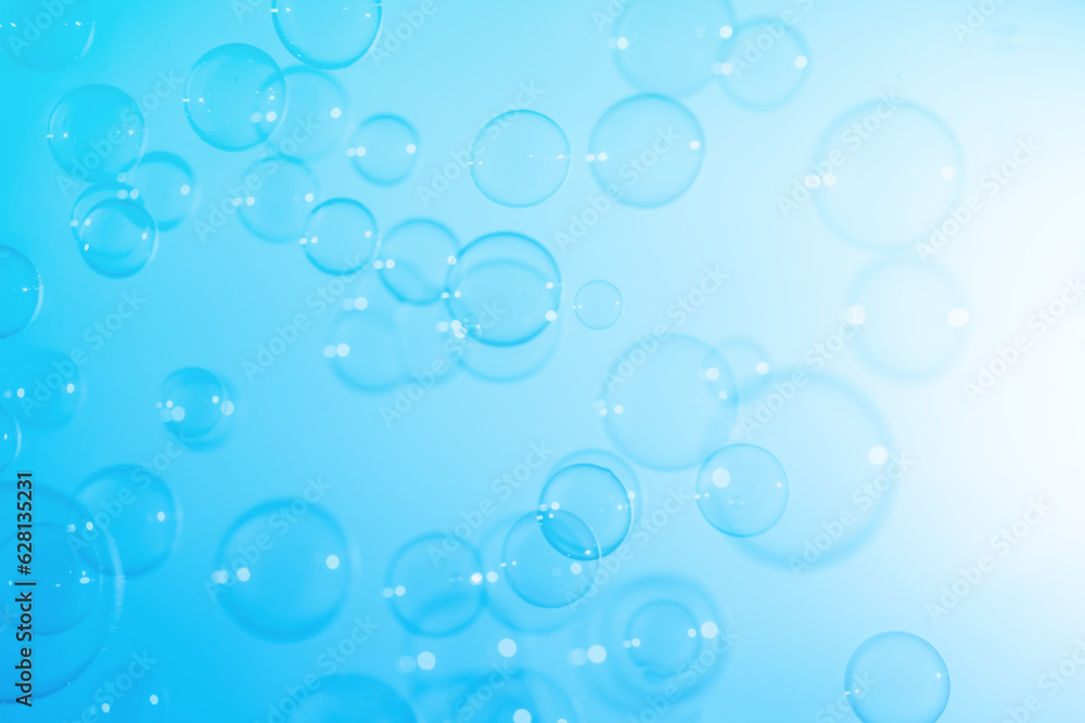 Refreshing of Soap Suds, Bubbles Water. Abstract Fun Background, Beautiful Transparent Shiny Blue Soap Bubbles Floating in The Air. Blue Gradient Blurred Background.