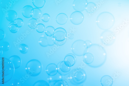 Refreshing of Soap Suds, Bubbles Water. Abstract Fun Background, Beautiful Transparent Shiny Blue Soap Bubbles Floating in The Air. Blue Gradient Blurred Background.