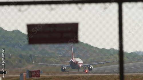 Jet airplane speed up before takeoff at Phuket airport, rear view. Tourism travel concept photo