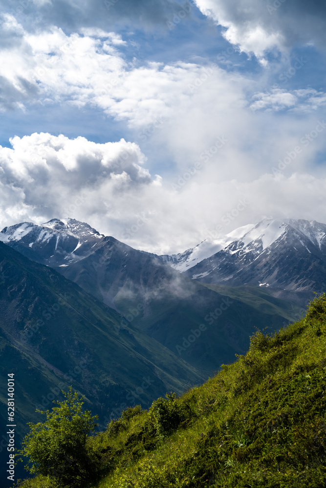 cloudy weather in a mountain gorge. clouds over mountain peaks