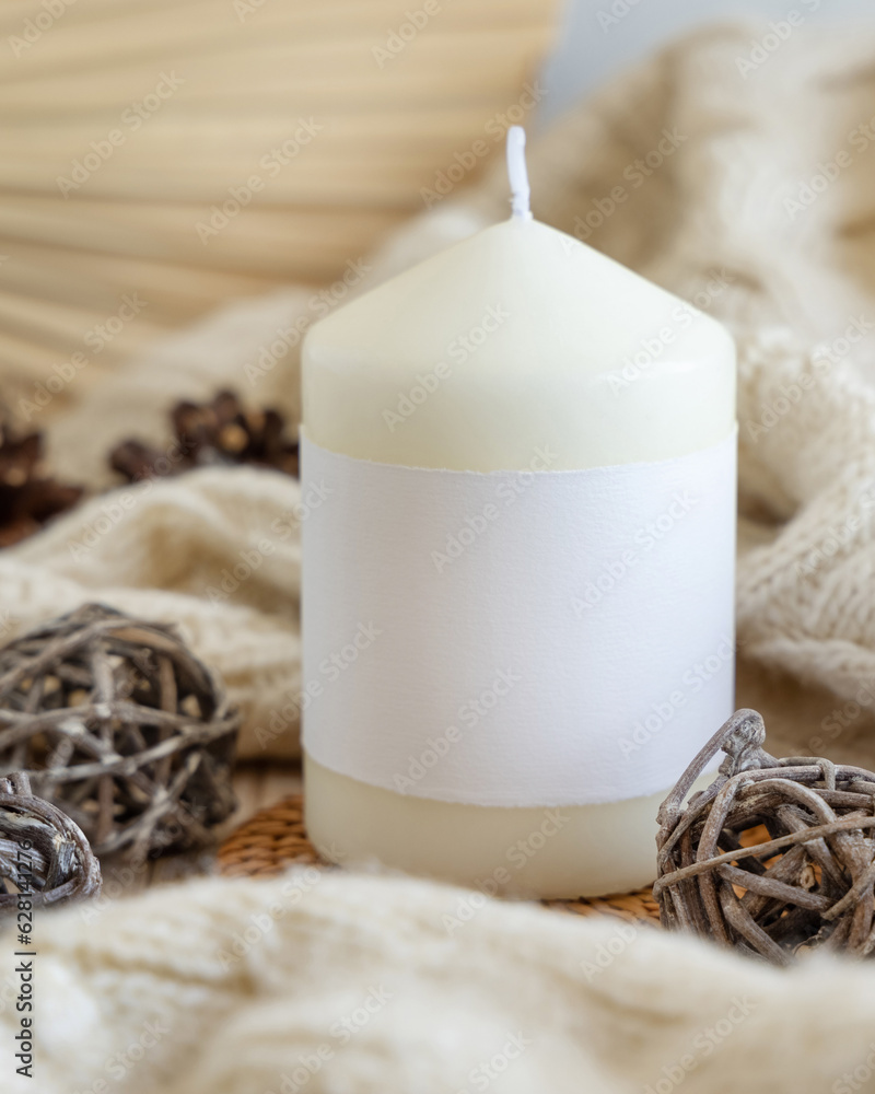 Candle with blank label near natural wooden decorations, Close up, copy space, mock up Candle with blank label near natural wooden decorations, Close up, copy space, mock up