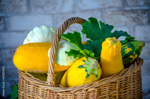fresh zucchini and squash in a wicker basket