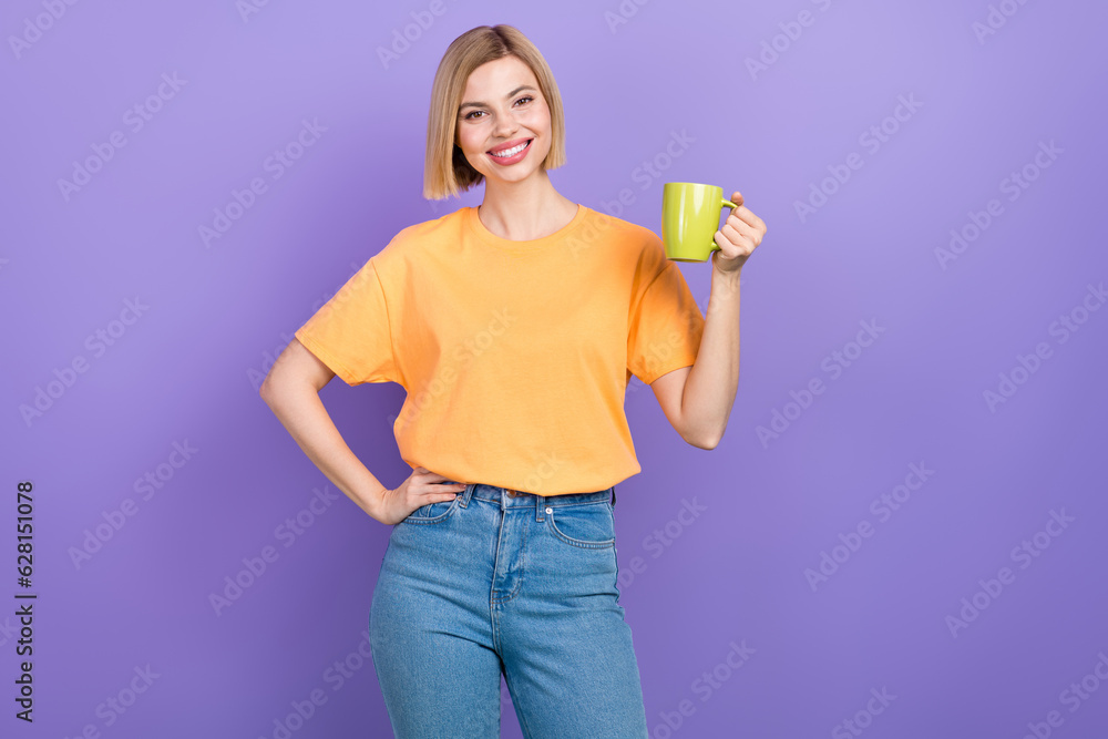 Portrait of cute adorable girl with bob hairdo dressed stylish clothes hold cup of tea hand on waist isolated on violet color background Portrait of cute adorable girl with bob hairdo dressed stylish clothes hold cup of tea hand on waist isolated on violet color background