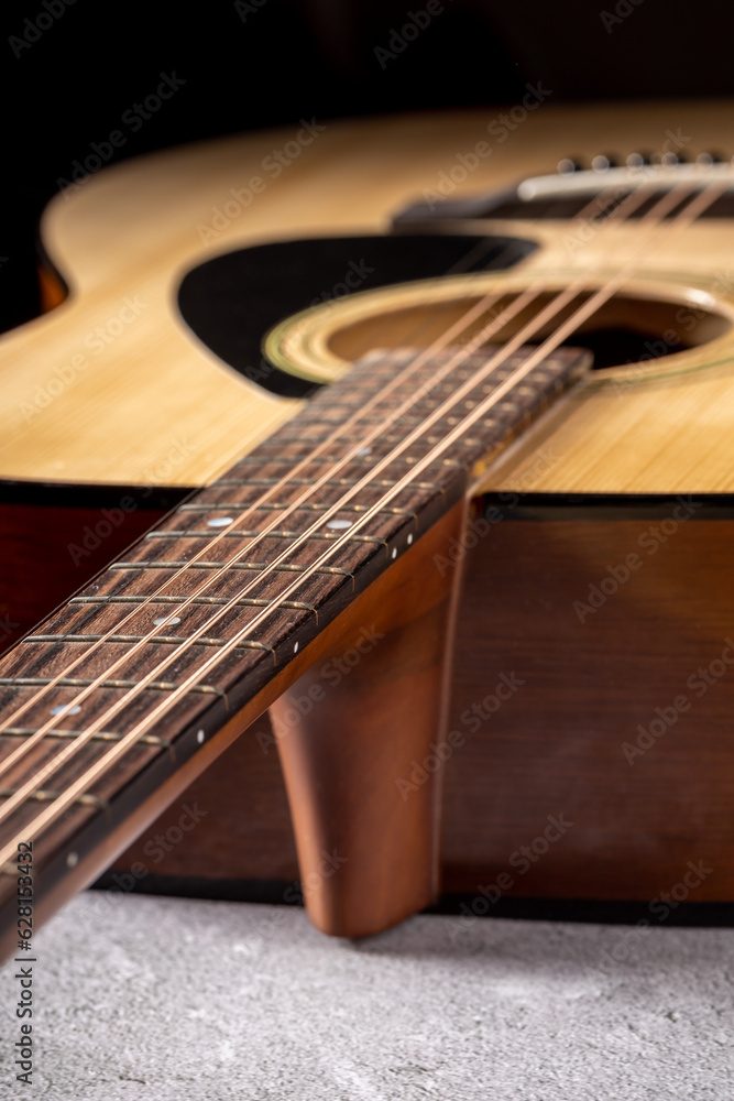 Fototapeta premium Classical guitar close up. Acoustic guitar on wood background.Music instrument concept