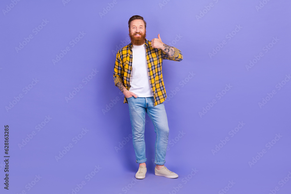 Full length photo of handsome man wear stylish outfit arm thumb up good job isolated on purple color background Full length photo of handsome man wear stylish outfit arm thumb up good job isolated on purple color background