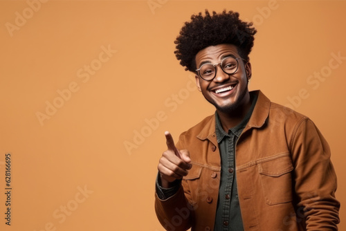 Man with afro hair pointing to blank space on orange background. Generative AI