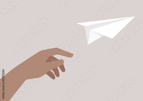 The innocence of childhood and the power of imagination embodied in a hand launching an origami paper plane