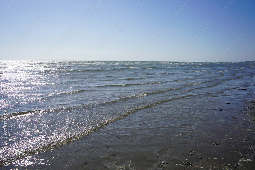 Small waves lapping up on a sandy beach