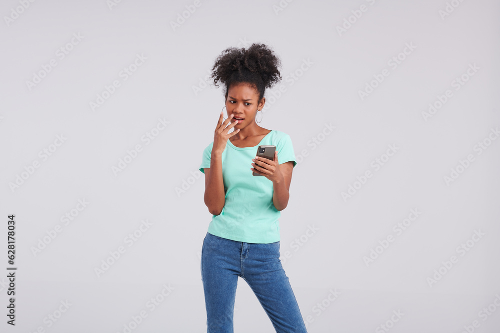 With chic communication, a Thai American woman dons a mint shirt and blue jeans, elegantly using her smartphone during the studio shoot. With chic communication, a Thai American woman dons a mint shirt and blue jeans, elegantly using her smartphone during the studio shoot.