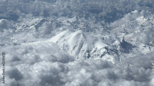 Aerial View of Steep Rocky Snowcapped Mountain Range on Beautiful Sunny Day. High quality 4k footage