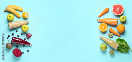 Bottles of healthy smoothies and ingredients on light blue background with space for text