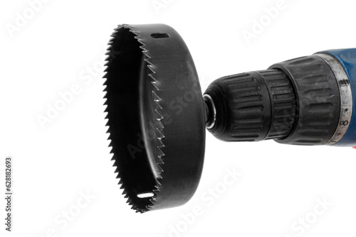 Foto hole saw with attachment on an electric screwdriver, for drilling round holes in
