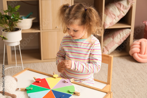 Cute little girl playing ma...