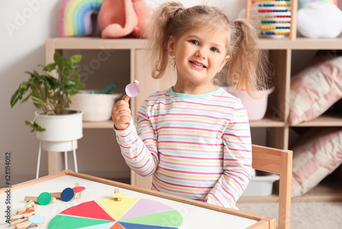 Cute little girl playing ma...