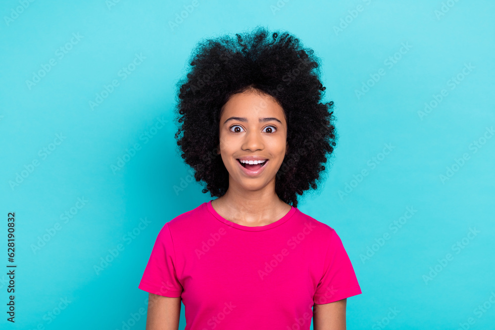 Photo of excited funky little girl dressed pink t-shirt smiling open mouth isolated teal color background Photo of excited funky little girl dressed pink t-shirt smiling open mouth isolated teal color background