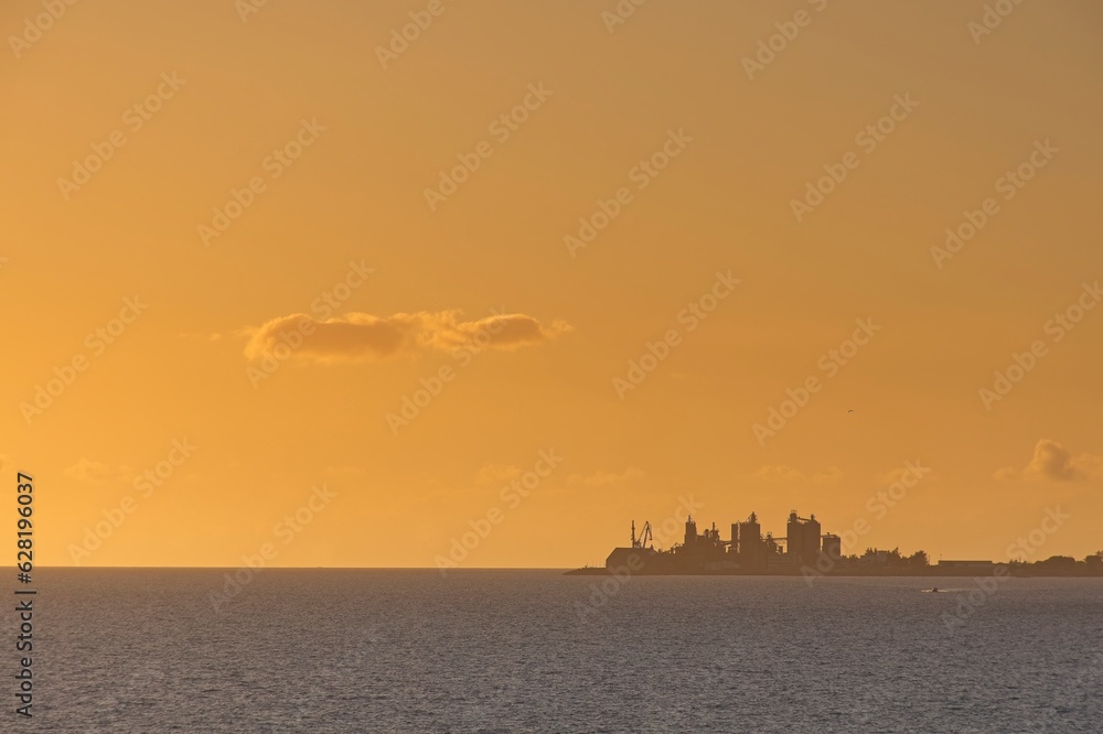 Fototapeta premium Orange sunset over the sea during summer in Maspalomas, Gran Canaria, Spain