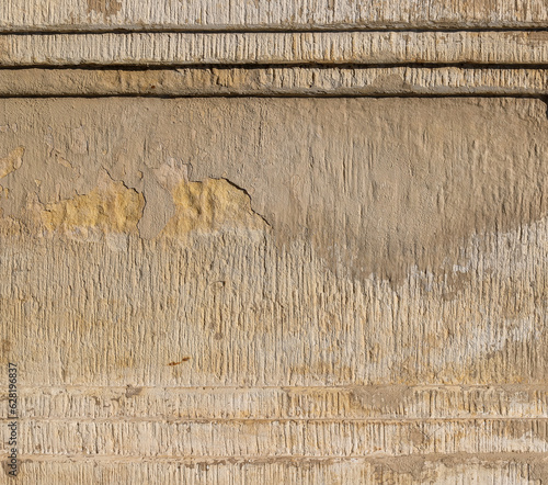 Texture of the old cracked terraced wall covered with beige stucco as an architectural background with copy space photo