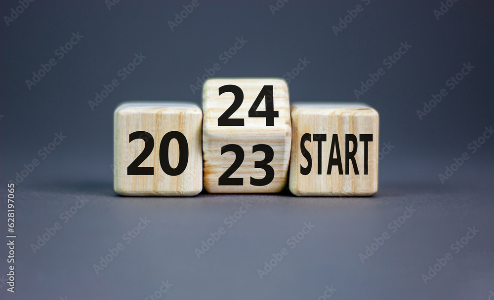 2024 start new year symbol. Businessman turns a wooden cube and changes words Start 2023 to Start 2024. Beautiful grey table grey background, copy space. Business 2024 start new year concept. 2024 start new year symbol. Businessman turns a wooden cube and changes words Start 2023 to Start 2024. Beautiful grey table grey background, copy space. Business 2024 start new year concept.