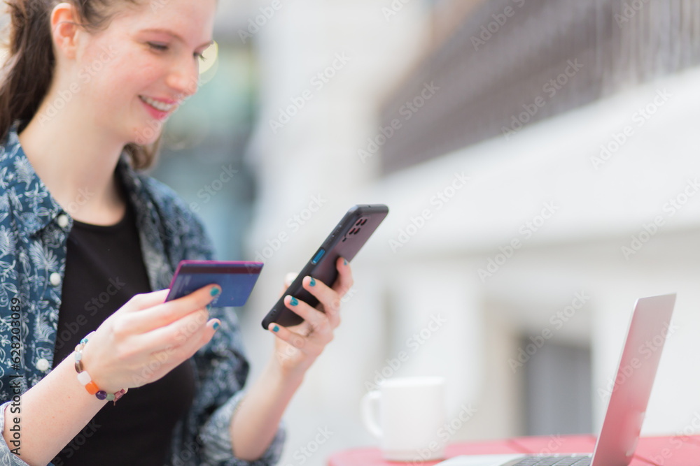 Smiling woman shopping online with her cell phone Smiling woman shopping online with her cell phone