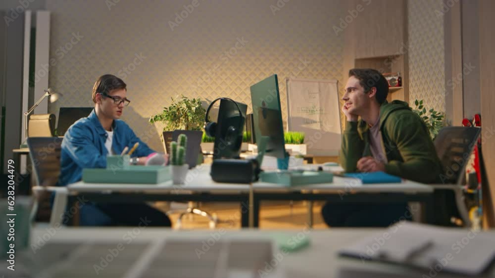 Smart startupers talking together at computer work room. Creative team working Smart startupers talking together at computer work room. Creative team working