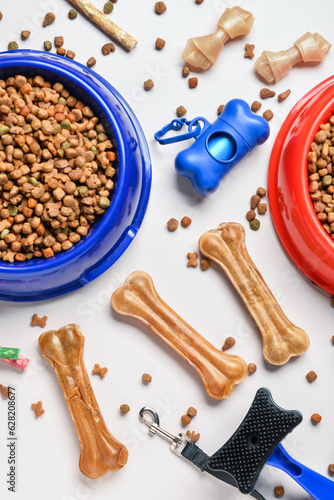 Composition with different dog food and accessories on light background, closeup