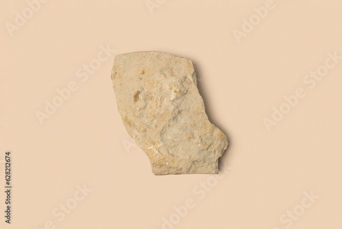 Stone Podium for promotion on beige Background. Natural rock pedestal. Beauty product mockup. Scene to show products. Showcase, display case. Top View soft shadow Flat lay. Trendy neutral color. Space