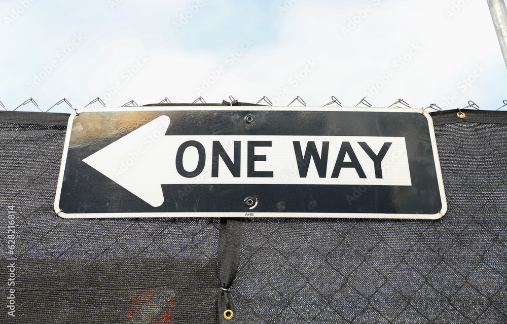 one-way sign on a city street, symbolizing direction, restriction, and adherence to a predefined path in life. Decisions and choices one-way sign on a city street, symbolizing direction, restriction, and adherence to a predefined path in life. Decisions and choices