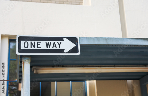 one-way sign on a city street, symbolizing direction, restriction, and adherence to a predefined path in life. Decisions and choices photo