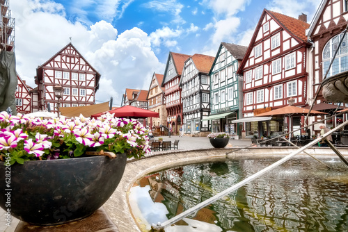 Traditional half timbered houses and fountain on marketplace in old town Fritzlar in Germany photo