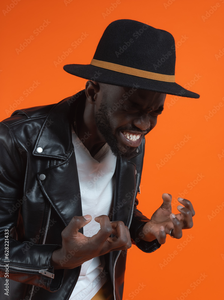 Angry black man in leather cloth and hat with anxious face Angry black man in leather cloth and hat with anxious face