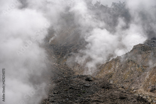 Wisps of smoke around the crater scattered rocks