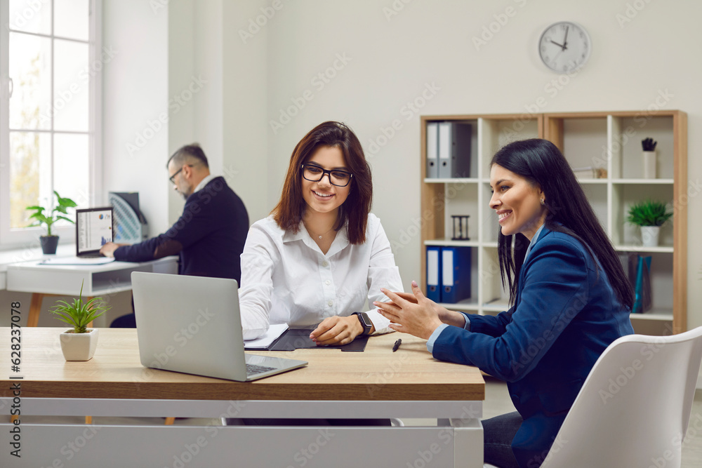 Happy young woman consulting at bank manager, financial advisor or loan broker. Smiling female client looking at laptop screen. Estate agent consulting customer about mortgage making offer Happy young woman consulting at bank manager, financial advisor or loan broker. Smiling female client looking at laptop screen. Estate agent consulting customer about mortgage making offer