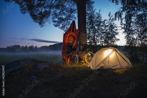 Inflatable boat with a bicycle in a tourist camp photo