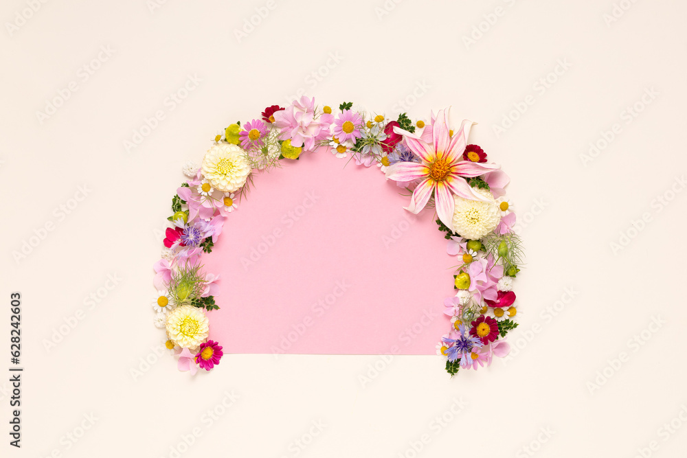 Creative layout made with flowers and paper tape for text on bright beige background. Flat lay. Spring minimal concept. Holiday mock up greeting card. Creative layout made with flowers and paper tape for text on bright beige background. Flat lay. Spring minimal concept. Holiday mock up greeting card.