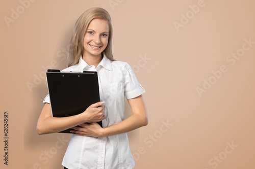 Beautiful happy business woman posing on background