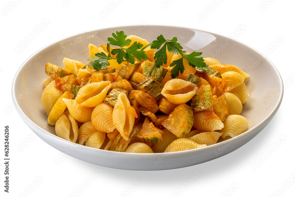 Conchiglie rigate pasta. Macaroni in shape of ridged shell with courgette and tomato sauce with parsley leaves in white dish isolated Conchiglie rigate pasta. Macaroni in shape of ridged shell with courgette and tomato sauce with parsley leaves in white dish isolated
