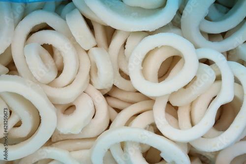 frosted squid body rings clos up photo on white table background