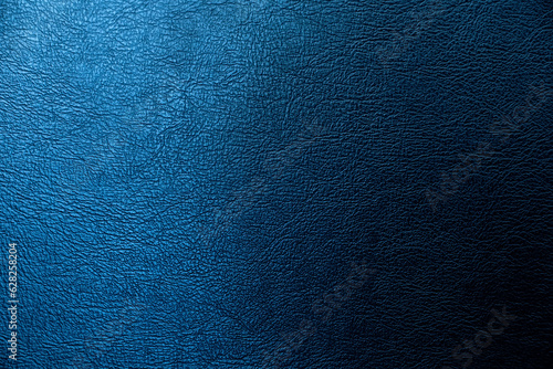 The surface of the black leather is Dark shaded by blue light.  Embossed pattern for luxury decoration or input text. photo