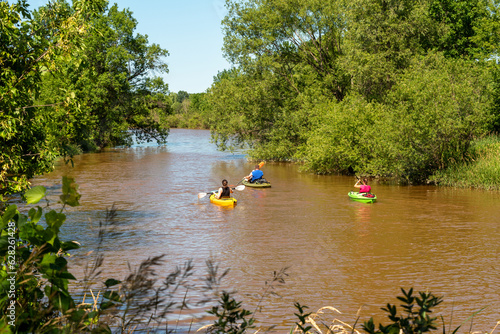 Kayakers paddling on the river in summer