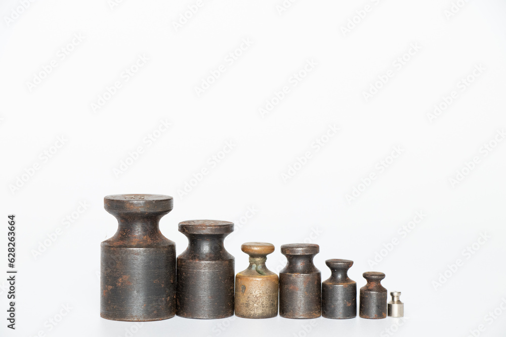Old rusty weights for scales of different sizes and weights on a white background Old rusty weights for scales of different sizes and weights on a white background