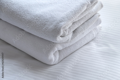clean white towels on the hotel bed. feels cozy, comfort and relax